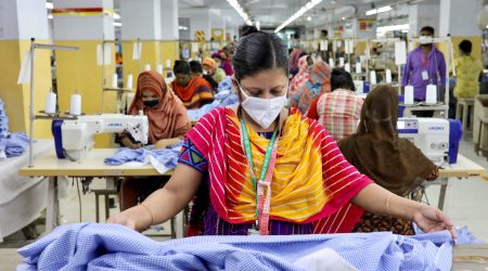 FILE PHOTO: A woman works in a garment factory, as factories reopened after the government has eased the restrictions amid concerns over coronavirus disease (COVID-19) outbreak in Dhaka, Bangladesh, May 3, 2020. REUTERS/Mohammad Ponir Hossain