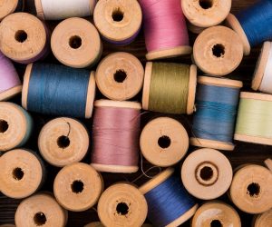 flat-lay-colored-thread-spools_23-2148242051