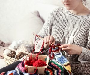 woman-knits-knitting-needles-couch_169016-6294