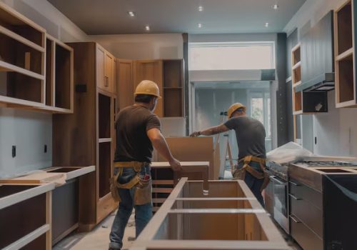 two-construction-workers-installing-wooden-cabinets-modern-kitchen-renovation-with-tools-materials-around_124507-306430