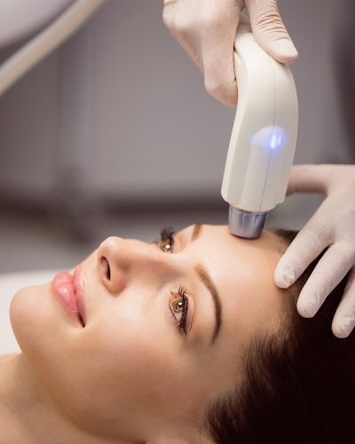 Female patient receiving cosmetic treatment at clinic